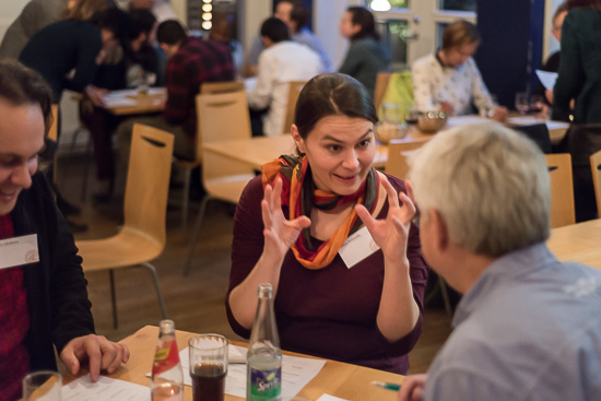 Two people are talking at a table.