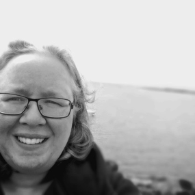 A selfie with a lake in the background.