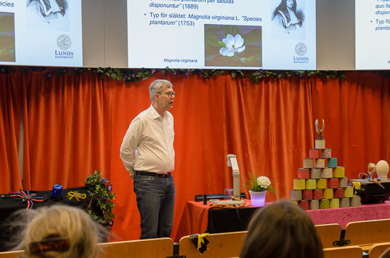 A person is standing giving a lecture.