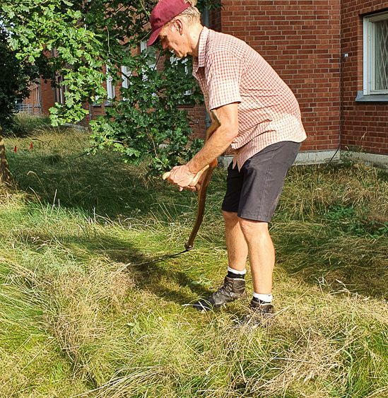 A person is mowing grass. Photo.