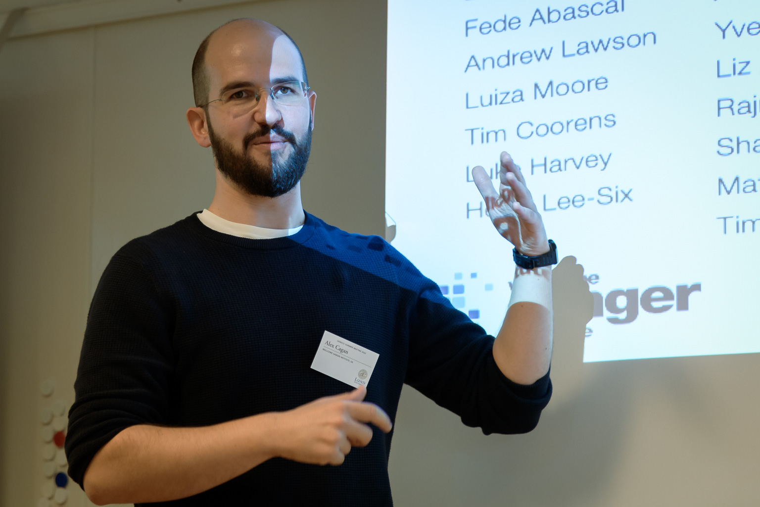 A person is standing in front of a presentation. Photo.