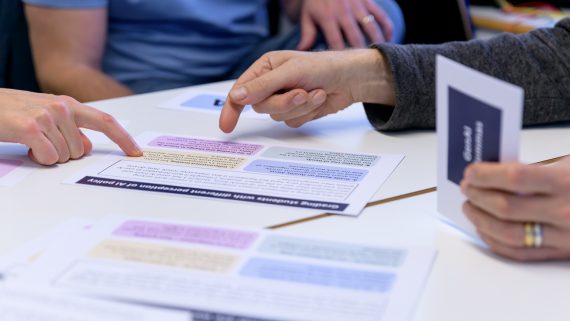 Hands that are pointing on text. Photo.
