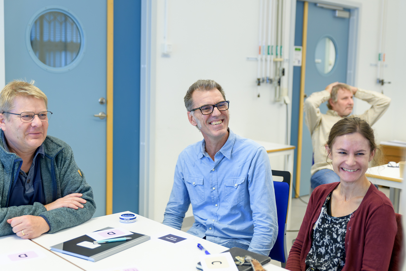 Three smiling people. Photo.